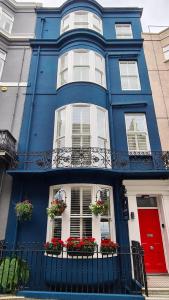 a blue house with flowers in the windows at Red Brighton Blue in Brighton & Hove