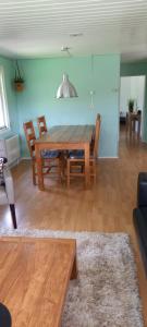 a living room with a wooden table and chairs at 't Vosje in Ermelo