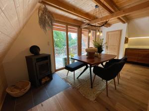 a living room with a table and a wood stove at Wildkräuter Hexenhaus in Mauth