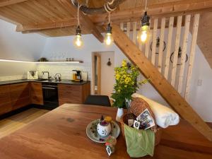 a kitchen and dining room with a wooden table at Wildkräuter Hexenhaus in Mauth +19 photos
