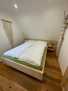 a bedroom with a bed in a room at Wildkräuter Hexenhaus in Mauth +19 photos