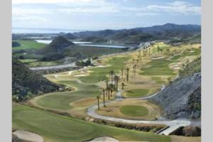 an aerial view of a golf course with palm trees at Casa, sol y playa 365 días!! in San Juan de los Terreros
