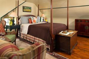 sypialnia z łóżkiem z baldachimem i salon w obiekcie Ashby Inn & Restaurant w mieście Paris