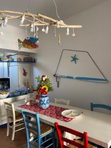 a kitchen with a table with chairs and a table sidx sidx at Rosanna Maison in Ischia