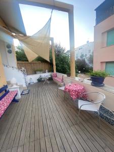 a balcony with chairs and tables and a large window at Rosanna Maison in Ischia