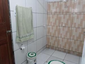 een badkamer met een douche en een groene handdoek bij Salinas praia do atalaia in Salinópolis +33 foto's