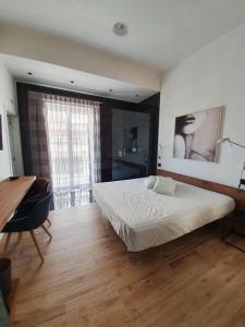 a bedroom with a large bed and a wooden floor at MY HOUSE LUXURY HOME in Marsala