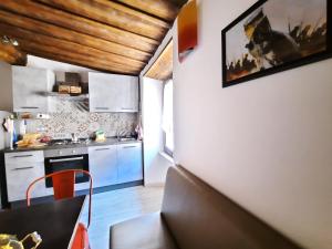 une cuisine avec des armoires blanches et une table dans une pièce dans l'établissement Viterbo alloggio turistico hipster house, à Viterbe