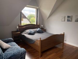 a bedroom with a bed and a large window at Apartament Olszynka in Gdańsk