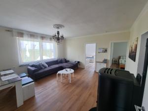 a living room with a couch and a table at Ferienhaus mit Ausblick in Brilon