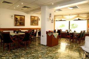 a dining room filled with tables and chairs at Hotel Mishel in Kocherinovo