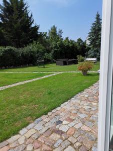 a garden with a park with a bench and grass at Fewo Freya in der Ostseeresidenz Gendarm in Wischuer +22 photos