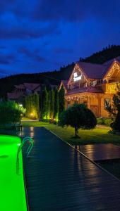 a house with a green light on a driveway at Villa "Затишна" in Mykulychyn