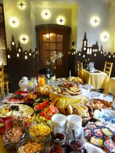 a table topped with lots of different types of food at Hotel U Kříže in Prague