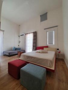 a bedroom with a bed and a ottoman at MY HOUSE LUXURY HOME in Marsala