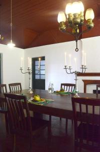 a dining room table with chairs and a chandelier at Sir John's Bungalow in Matale