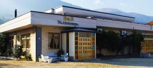 a building with a sign on the front of it at B&B Nottetempo in Paupisi