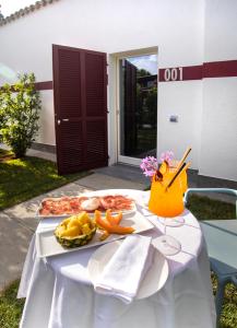 una mesa blanca con un plato de comida. en Country House La Cipolla D'oro, en Potenza Picena