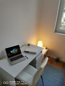a white desk with a laptop computer on it at CITY CENTER PEARL #new#free reserved parking in garage elevator direct access#business and pleasure#city view&balcony&sunny&cafes&markets&tram#city center in Zagreb
