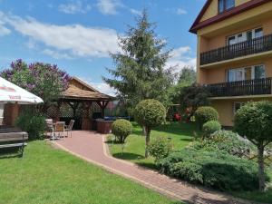 a house with a garden and a patio at Noclegi Michaś in Krasnobród