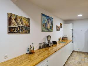 a kitchen with white walls and a wooden counter top at Casa do Armador in Setúbal