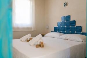Katil atau katil-katil dalam bilik di Albarìa Favignana Apartments