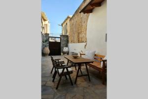 a patio with a wooden table and chairs at The nest project by almelon in Límnai