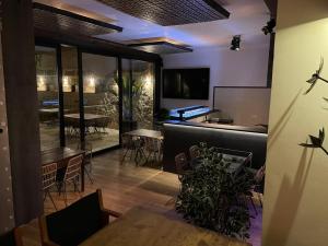 a restaurant with tables and chairs and a bar at Petit Hotel C'an Mel in Caʼs Concos