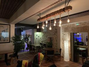 a restaurant with lights hanging from the ceiling at Petit Hotel C'an Mel in Caʼs Concos