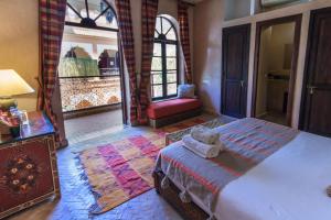 1 dormitorio con 1 cama y 1 silla en una habitación en Riad Nabila, en Marrakech