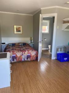 a bedroom with a bed and a hallway with a bathroom at Motel Glenn in Perce
