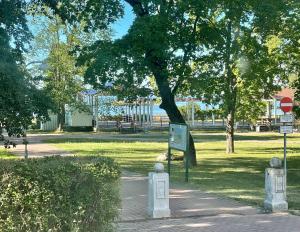 un parque con un árbol y un cartel en el césped en Rüütli 1 - sea view apartement in Haapsalu Old Town en Haapsalu