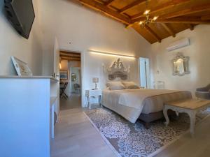 a bedroom with a large bed and a table at Casa do Toupeiro in Óbidos