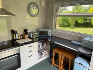 a kitchen with a counter top and a window at The Piggery Pod in Sittingbourne