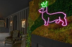 un néon d'un cerf sur un mur dans l'établissement The Chesterton Hotel, à Bicester