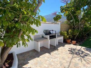 a white desk sitting on a patio with trees at Arafo Sunset Villa in Arafo