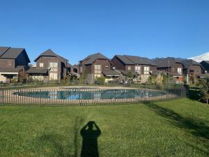 a shadow of a person standing in front of a pool at Condominio Costa Pucon in Pucón