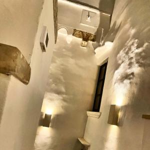 a hallway with a cloud mural on the wall at Palazzo NUR in Gallipoli