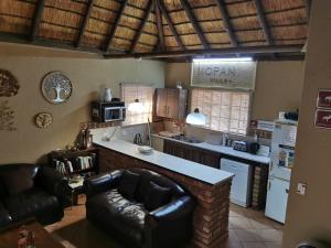 a kitchen with a couch and a counter in it at Mopani Villa in Marloth Park