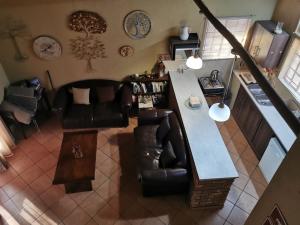 an overhead view of a living room with a counter and chairs at Mopani Villa in Marloth Park