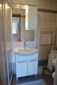 W łazience znajduje się biała umywalka i prysznic. w obiekcie Rooms & Apartments Kvasić w Krku +37 zdjęć