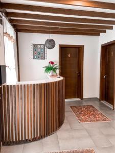 a lobby with a wooden partition with a plant on it at Apartments HAN Alifakovac-Sarajevo in Sarajevo