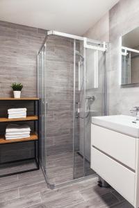 a bathroom with a shower and a sink at Galeria Apartments - Jasná in Demanovska Dolina +28 photos