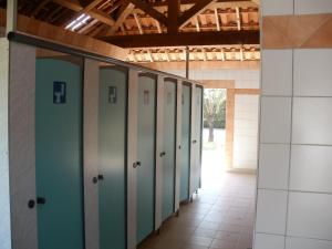 a row of lockers in a room with a hallway at Camping les Silhols in Lagorce