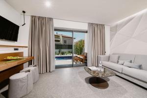 a living room with a couch and a table at Origami Boutique Residences in Nafplio