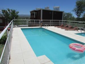 a large swimming pool on the roof of a building at La Villa Inn in Villa Carlos Paz