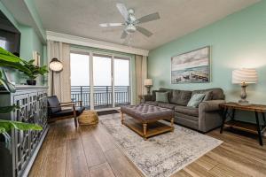 a living room with a couch and a large window at Unit 1207 Ocean Walk - 1 Bedroom Ocean Front in Daytona Beach