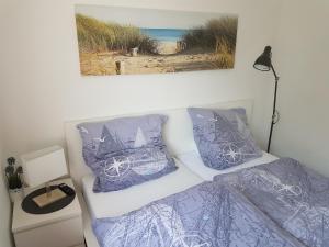 a bedroom with a bed and a picture of a beach at Eckernförde Baltic Beach in Eckernförde