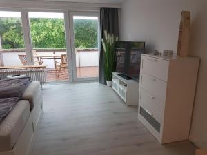 a bedroom with a bed and a tv and a dresser at Eckernförde Baltic Beach in Eckernförde