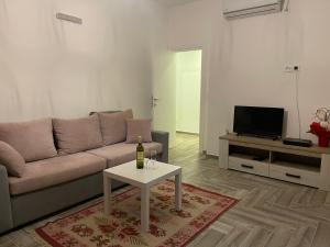 a living room with a couch and a table at Belami luxury apartments in Ulcinj
